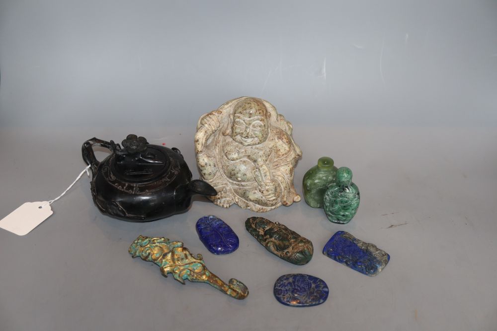 A group of Chinese hardstone carvings, including a Buddha, a lapis lazuli teapot, a belt hook, etc.